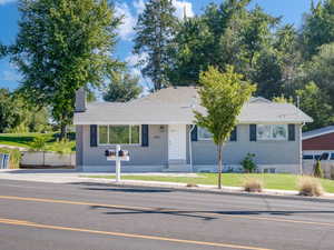 Ranch-style home with a front lawn