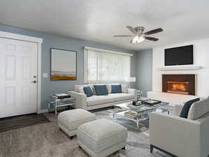 Living room featuring a textured ceiling, carpet, ceiling fan, and a brick fireplace