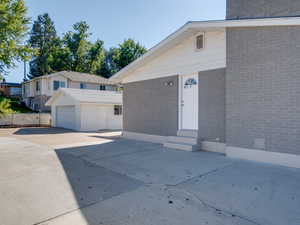 View of front of property featuring a garage and an outbuilding