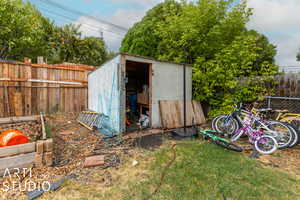 View of outdoor structure with a yard