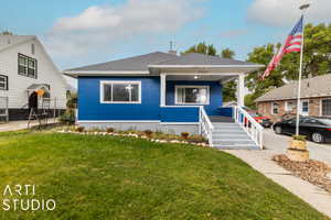 View of front of house featuring a front lawn and a porch