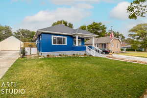 Bungalow with a front yard and a porch