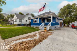 Bungalow-style home featuring a front lawn and a porch