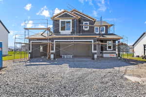 View of front facade featuring a garage