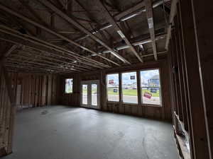 Living room, Dining, and Kitchen featuring a wealth of natural light and 9' ceilings with views of common space and mountains