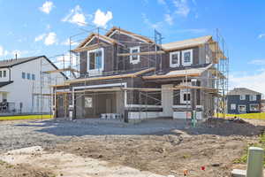 View of front of property with a balcony and a patio