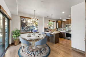 Dining space featuring light wood-type flooring and sink