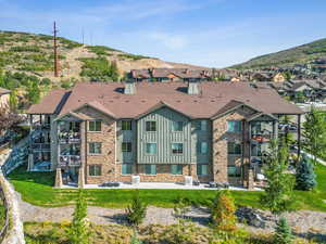 Exterior space with a mountain view, a balcony, and a patio area