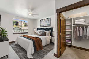 Carpeted bedroom with ceiling fan