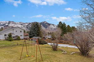 View of yard featuring a playground and a mountain view