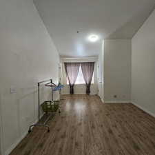 Empty room with dark hardwood / wood-style floors