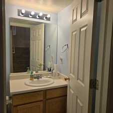 Bathroom featuring a textured ceiling and vanity