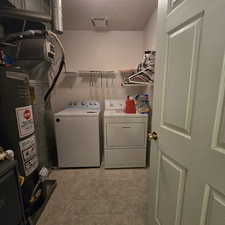 Laundry area with water heater and independent washer and dryer