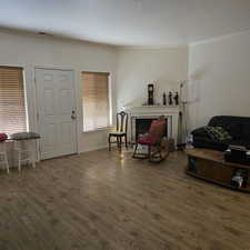 Interior space with dark wood-type flooring and crown molding