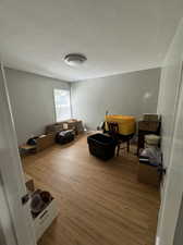 Sitting room featuring a textured ceiling and hardwood / wood-style flooring