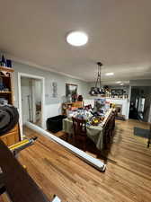 Interior space with crown molding and light hardwood / wood-style floors