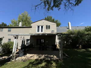 Back of property featuring a yard and a patio area