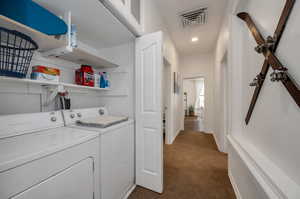 Washroom featuring dark colored carpet and independent washer and dryer