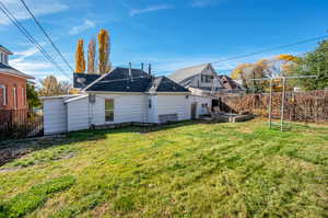 Rear view of house featuring a lawn