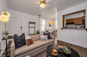 Living room featuring dark hardwood / wood-style floors and ceiling fan