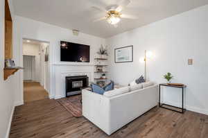 Living room featuring ceiling fan and hardwood / wood-style flooring