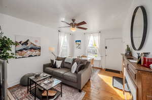 Living room featuring light wood-type flooring and ceiling fan