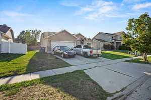 View of front facade with a front lawn and a garage