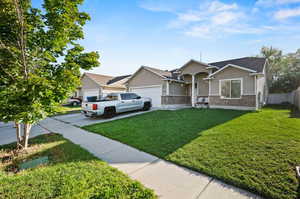 Single level home with a two-cars garage and a front yard