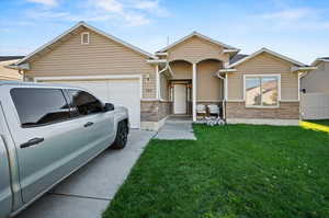 View of front facade with a front lawn and a garage