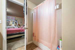 Master bathroom featuring shower / bath combo with shower curtain and tile patterned floors