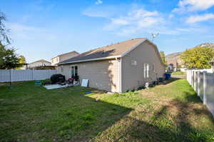 Back of property featuring a yard and a patio area