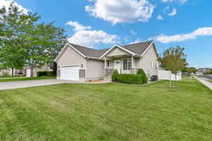 Single story home featuring a front lawn