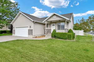 View of front of house with a garage and a front yard