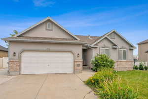 Single story home with a garage and a front yard