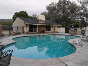 View of swimming pool with a patio and a mountain view