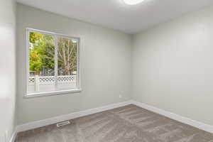 Bedroom #3   featuring a textured ceiling and carpet