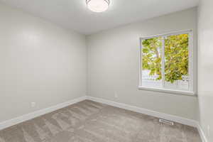 Bedroom #4  featuring carpet and a healthy amount of sunlight