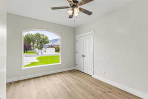 Bedroom/Office  Unfurnished room with ceiling fan and light hardwood / wood-style floors