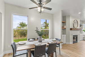 Dining area with light wood-type flooring and ceiling fan