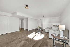 Living room with dark wood-type flooring