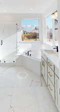 Bathroom featuring a mountain view, a bath, and vanity