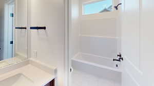 Bathroom featuring vanity and shower / bathing tub combination