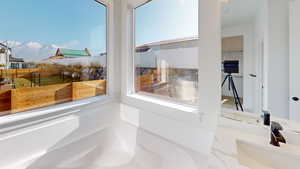 Bathroom featuring a mountain view, a washtub, and sink