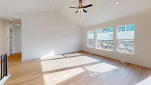 Spare room featuring ceiling fan, high vaulted ceiling, and light hardwood / wood-style floors