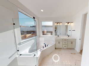 Bathroom with vanity and a bath