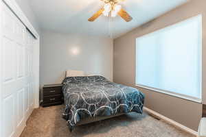 Bedroom with carpet flooring, a closet, and ceiling fan