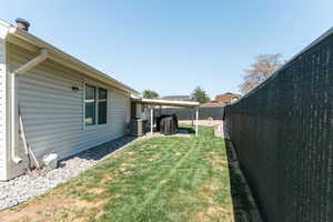 View of yard featuring a patio and central AC unit