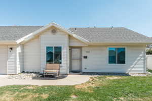 Rear view of house featuring a yard