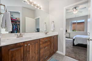 Bathroom featuring tile patterned flooring, vanity, and ceiling fan