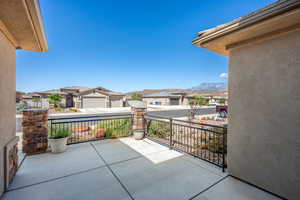 View of patio / terrace featuring a mountain view and a garage